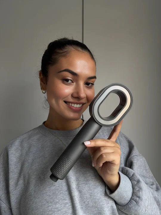 Brunette Woman smiling holding the PureRain Halo filtered showerhead